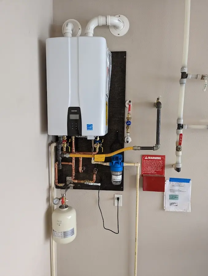 Professional plumber installing copper piping in a Mount Pocono home